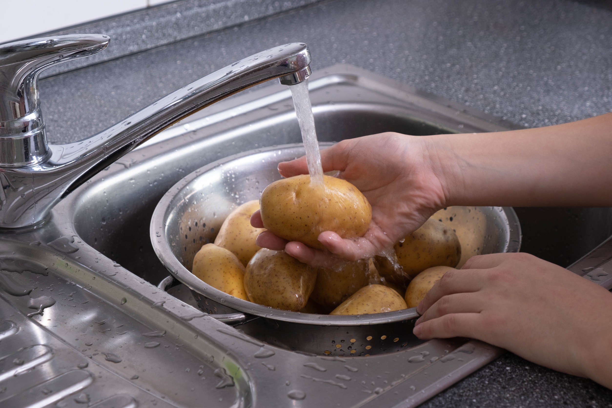 woman cleaning potatoes